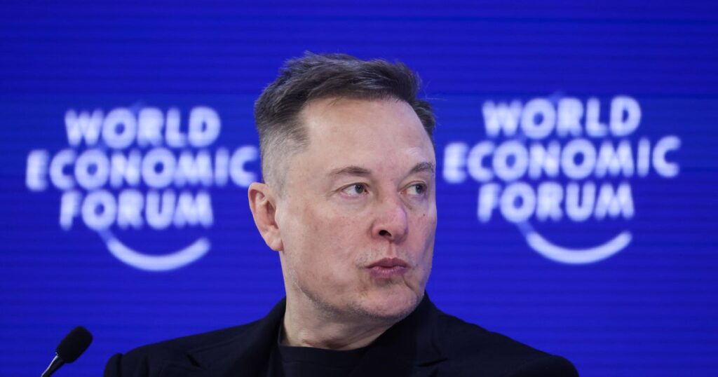 Elon Musk, a fierce Davos critic, tells World Economic Forum that robots will outnumber humans