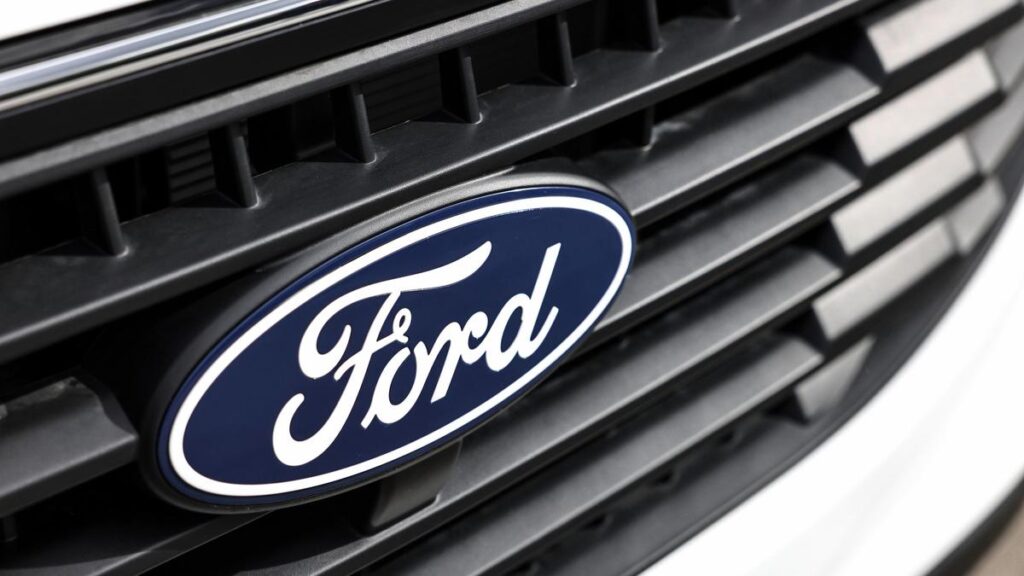Close-up of the Ford logo on the car's front grille.