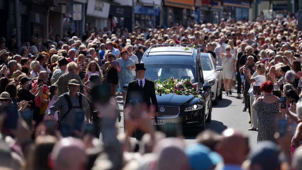 Crowd sings Bonnie Tyler hit as coffin returns home