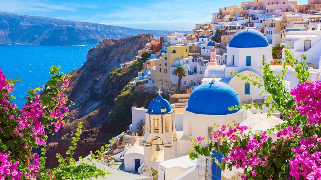 Santorini crowds driven by social media line up at Oia’s blue-domed churches for photos