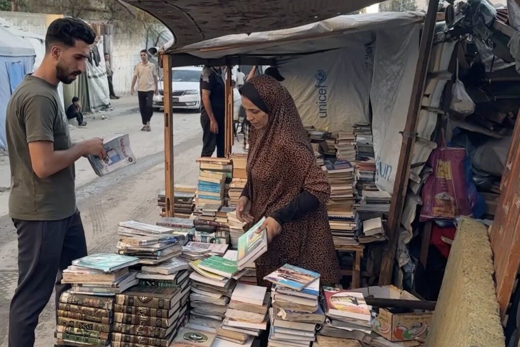 Gaza woman rescues books from rubble to keep education alive | Gaza
